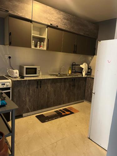 a kitchen with a counter and a refrigerator in it at Cnc BnB-Kimana-2bedrooms in Oloitokitok 