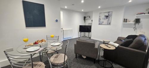 a living room with a couch and a table at Modern, Spacious, Central 2-Bed Plymouth Apartment in Plymouth