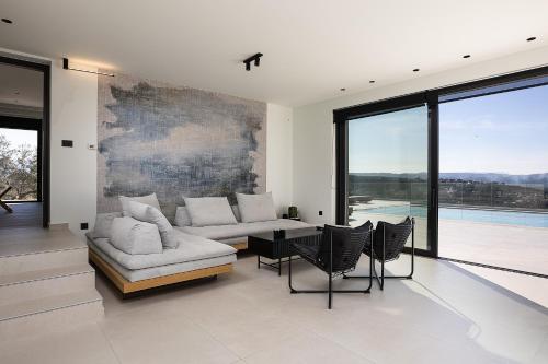 a living room with a couch and a table and chairs at Villa Kafkales Maleme - Heated Pool in Maleme