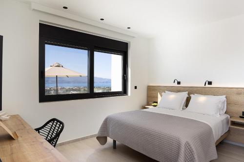 a bedroom with a large bed and a window at Villa Kafkales Maleme - Heated Pool in Maleme