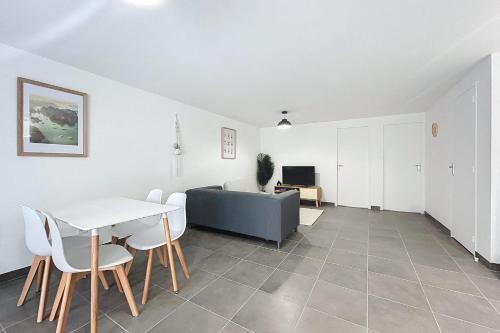 a living room with a table and a couch at Bright T3 for 4 people in Cuxac-dʼAude