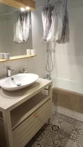 a bathroom with a sink and a bath tub at Private room à la Teste in La Teste-de-Buch