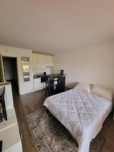 une chambre avec un lit et une cuisine avec une table dans l'établissement Studio 0237 Port Camargue, Piscine, Climatisation, 2 personnes, au Grau-du-Roi