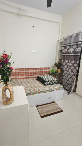 a room with a bed and a vase on a table at Chandrajyoti Villa 5 Ground floor Villa in Nagpur