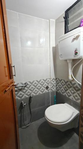 a bathroom with a white toilet and a sink at Chandrajyoti Villa 5 Ground floor Villa in Nagpur