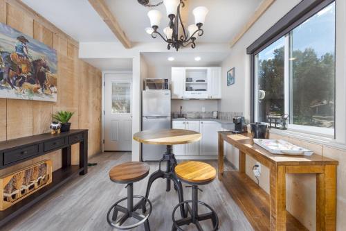 a kitchen with a fireplace and a table and stools at Sky Ranch Lodge in Sedona