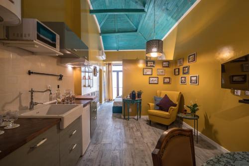 a kitchen with yellow walls and a blue ceiling at YBaixa - Boutique Apartments in Setúbal