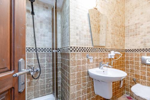 a bathroom with a toilet and a sink and a shower at Casa Roma Boutique Hotel in Bodrum City