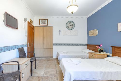 a hotel room with two beds and a tv at Casa Roma Boutique Hotel in Bodrum City