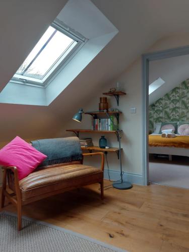 a attic room with a bench and a window at The Old Winery Loft in Edale