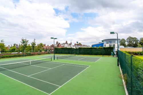 a tennis court with two tennis rackets on it at Swift Host - 4 Bedrooms - Beautiful Period Property - Parking - Garden in Norwich