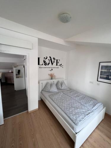 a white bedroom with a bed in a room at MaHome Apartments in Lofer
