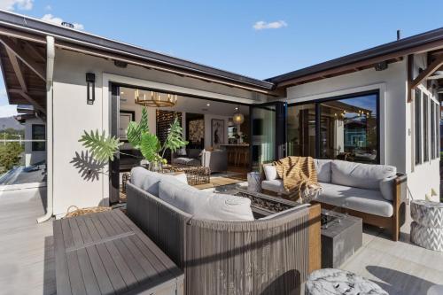 a patio with two couches and a table at Ocean Whispers home in Moss Beach