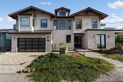 a large house with a garage at Ocean Whispers home in Moss Beach