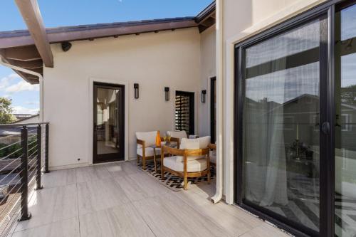 a patio with a table and chairs on a balcony at Ocean Whispers home in Moss Beach