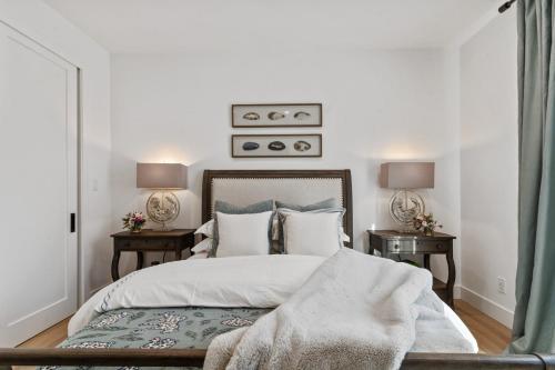 a bedroom with a large bed with two night stands at Ocean Whispers home in Moss Beach