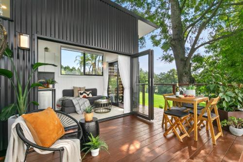 a screened in porch of a house with a table and chairs at 6SIXTEEN - Hot Tub or Cold Plunge, Infrared Sauna Launching March in Richmond