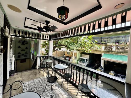 a balcony with chairs and a table and a bar at Park Avenue Boutique Hotel Manila in Manila