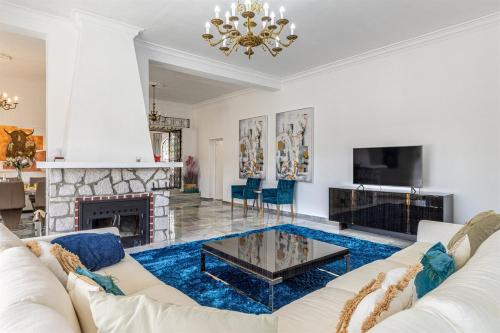 a living room with a white couch and a fireplace at Luxury villa with tennis & pool in Málaga