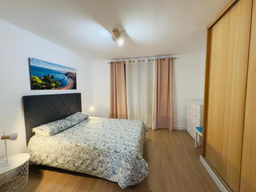 a bedroom with a bed and a painting on the wall at Mansa Beach I - Vv Playa San Juan in Guía de Isora