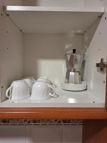 a shelf with two tea cups and a blender on it at Cazorla LIVE in Cazorla