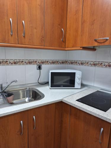 a kitchen with a sink and a microwave on a counter at Cazorla LIVE in Cazorla