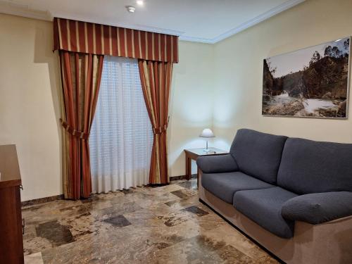 a living room with a couch and a window at Cazorla LIVE in Cazorla