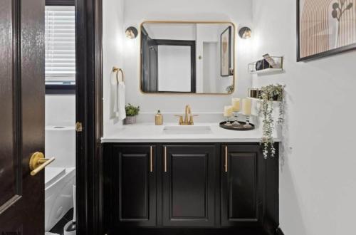 a bathroom with a sink and a mirror at Chic Haven- Close to Beach, Boardwalk & Casinos in Atlantic City