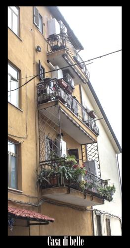 an apartment building with balconies and potted plants on it at La casa di Belle in Castelchiodato