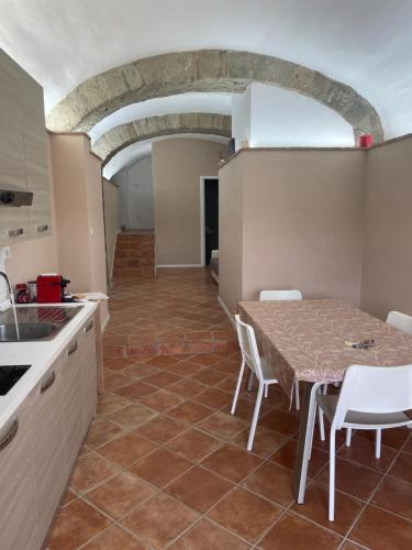 a kitchen and dining room with a table and chairs at CASA BELLAVISTA - Charming House in Campagnano di Roma