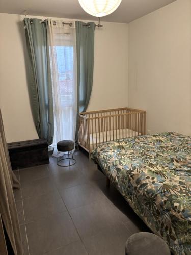 a bedroom with a bed and a chair and a window at Appart cosy in La Seyne-sur-Mer