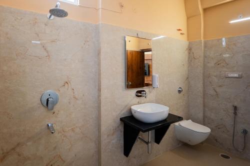 a bathroom with a sink and a shower and a toilet at Hotel Shiva Nilay Inn in Gorakhpur