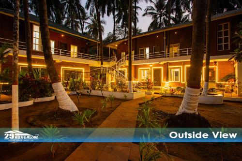 an outside view of a building with palm trees at Sea breeze Private Pool Villa - alibaug by 29 Bungalow in Nagaon
