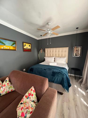 a bedroom with a bed and a couch at Bird Song in Roodepoort