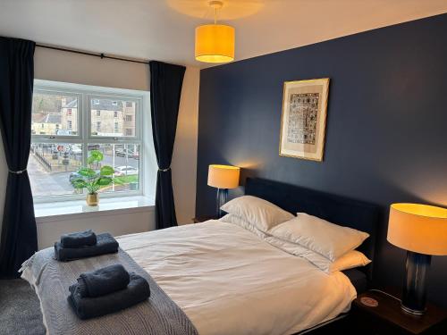 a bedroom with a bed with two towels on it at 16 Macgregor court, Oban in Oban