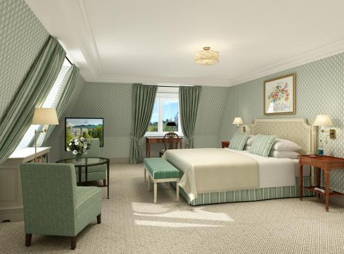 a hotel room with a bed and a chair at Brenners Park Hotel & Spa, Oetker Hotels in Baden-Baden