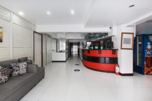 a living room with a couch and a bar at OYO 894 Cosmo Hotel P Campa Manila in Manila