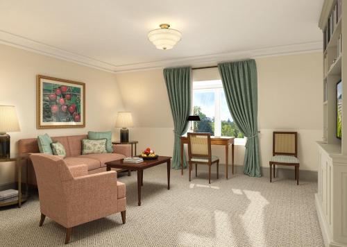 a living room with a couch and a table at Brenners Park Hotel & Spa, Oetker Hotels in Baden-Baden