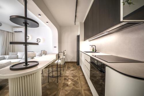 a kitchen with a counter and a bar with stools at Allegro Suites in Rethymno Town