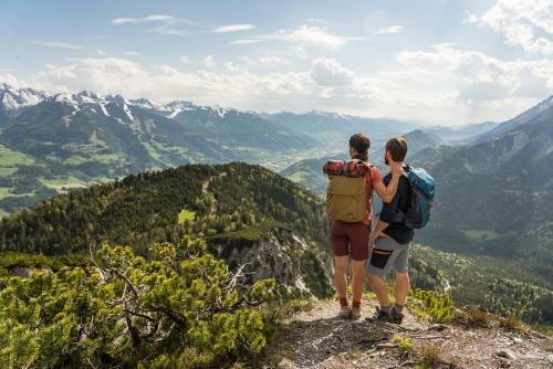 two people standing on top of a mountain at Falkensteiner Hotel Schladming Superior in Schladming