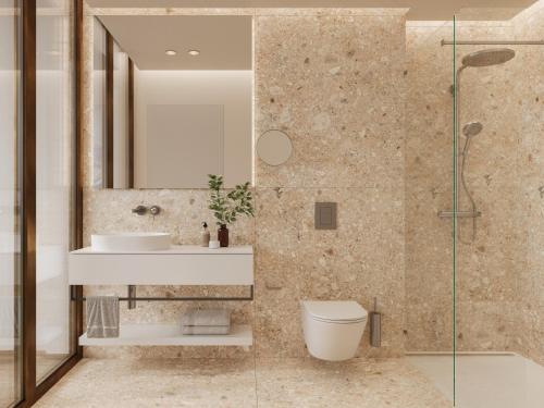a bathroom with a sink and a toilet and a mirror at Hôtel des Innovations in Marly-le-Grand