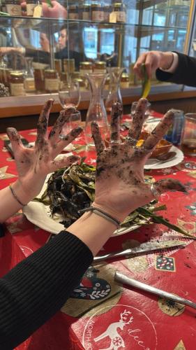 a person with their hands on a table with a plate of food at Hotel Valls Valira in Os de Civís