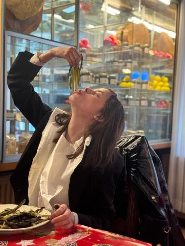 a woman sitting at a table drinking from a bowl of food at Hotel Valls Valira in Os de Civís