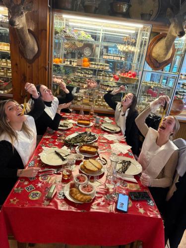 a group of women sitting at a table eating food at Hotel Valls Valira in Os de Civís