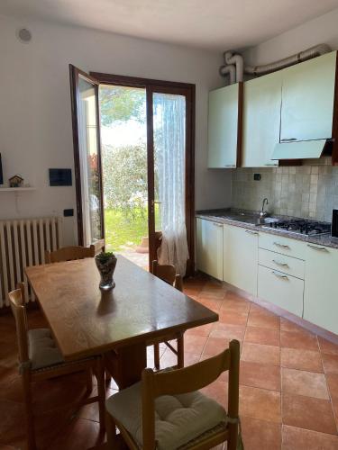 a kitchen with a wooden table and a dining room at Casale del Vacanziere in Certaldo