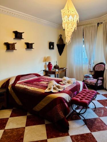a bedroom with a bed and a table and a chair at Ventana al mar , Tánger in Tangier