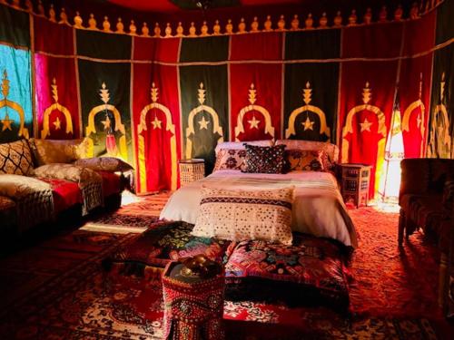 a bedroom with a bed in a room with colorful walls at Ventana al mar , Tánger in Tangier