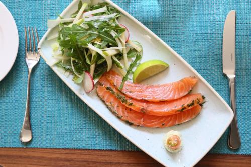 a plate of food with salmon and salad on a table at Vincci Liberdade in Lisbon