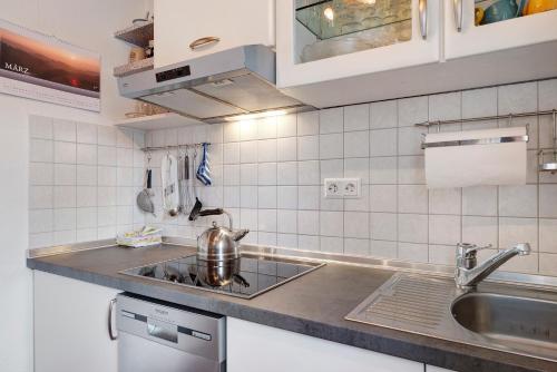 a kitchen with a sink and a counter top at Haus Janßen-Wehrle in Titisee-Neustadt