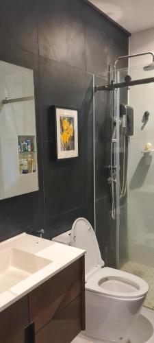 a bathroom with a shower and a toilet and a sink at สวนภาคินรัตน์ in Ban Talung